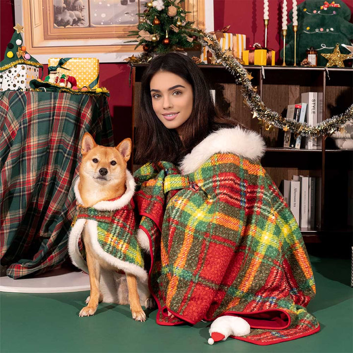 Dog looking festive in a red plaid poncho, perfect cozy pet clothes for the winter season.