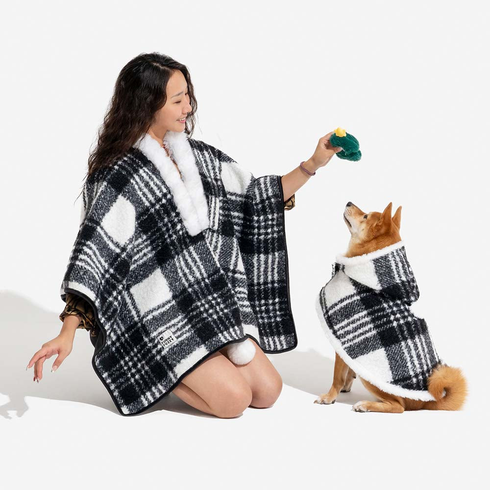 Owner and dog in matching plaid ponchos, front view, comfortable and warm dog apparel.