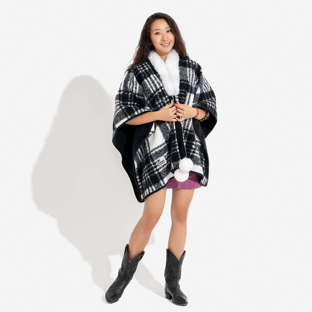 Detailed view of the plaid pattern on a dog's poncho, cozy polar fleece pet fashion.