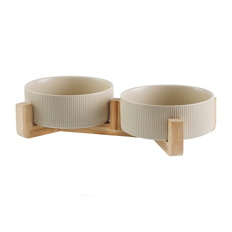 Set of two matt black ceramic pet bowls nestled securely in a contemporary wooden stand.