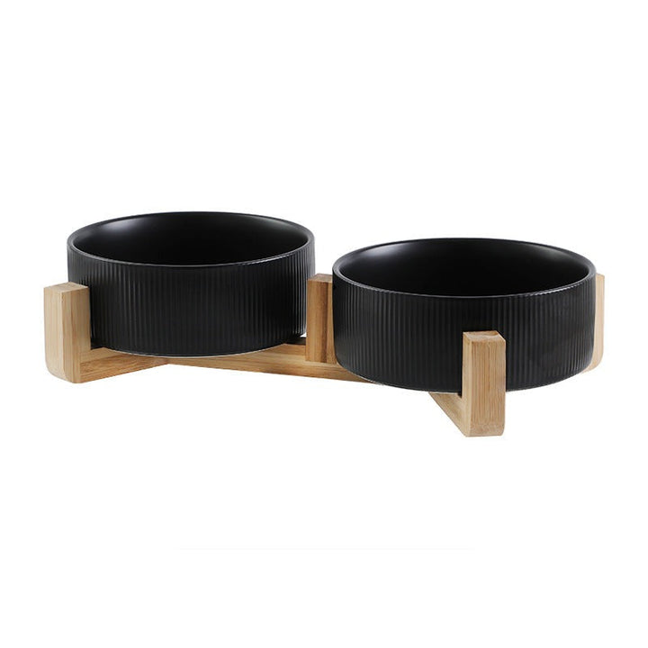High-quality pet feeding station with durable matt green ceramic bowls and a minimalist wooden stand.