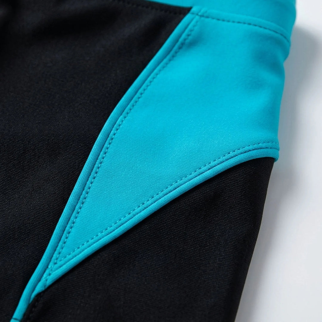 Fitted men's boxer swim trunks with stylish color-block design, perfect for athletic beach performance.