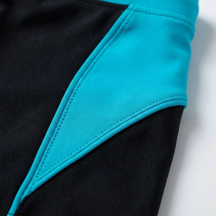 Fitted men's boxer swim trunks with stylish color-block design, perfect for athletic beach performance.