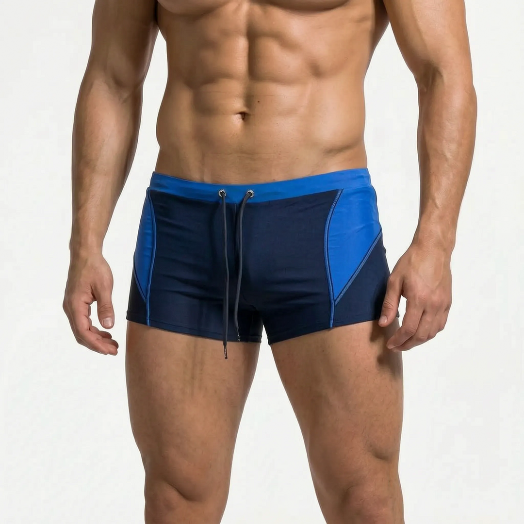 Secure fit men's boxer swim trunks, color-block for sporty beachwear & high-performance swimming.