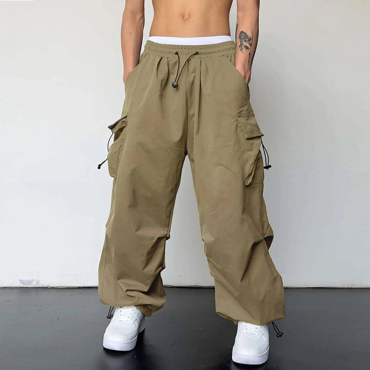 Urban style men's baggy cargo pants, inspired by Y2K fashion. Loose fit parachute design with practical multi-pockets.