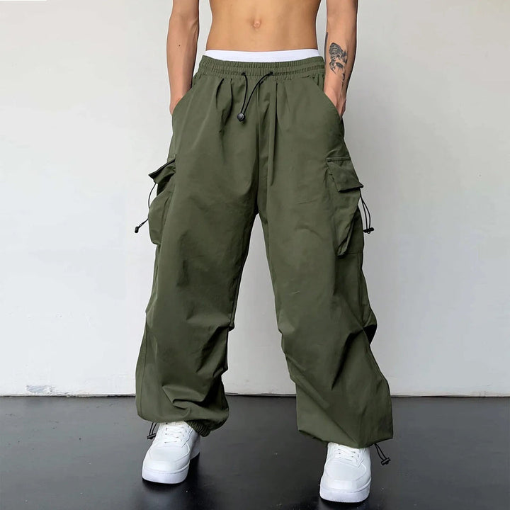 Comfortable men's loose fit parachute pants; baggy cargo design with elastic waist, ideal for casual Y2K streetwear.