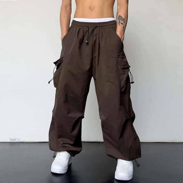 Multi-pocket men's baggy cargo parachute pants. Y2K streetwear utility style with a comfortable loose fit for urban fashion.