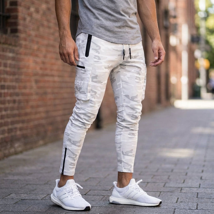 Men's black sports jogging trousers with zipper pockets for gym wear & active comfort. Tapered fit joggers.