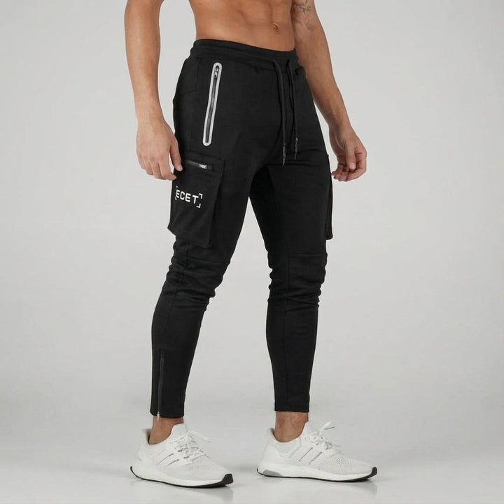 Modern men's gym wear joggers. Sleek tapered fit sports trousers with secure zipper pockets for training.