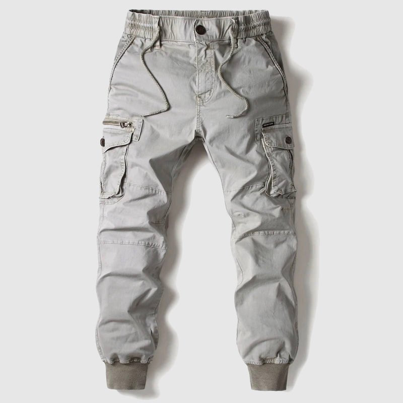 Grey tactical cargo pants for men, versatile design with adjustable waist & ample storage for daily activities.