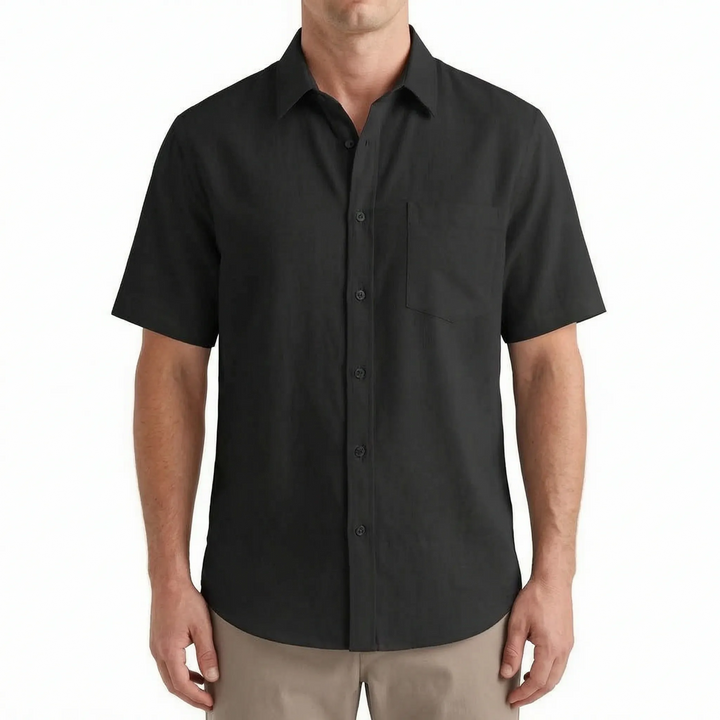 Model wearing a men's casual short-sleeve button-up shirt. Perfect apparel for relaxed summer occasions.