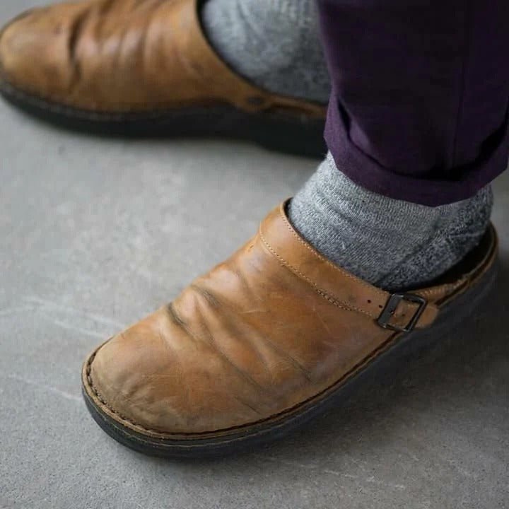 Modern men's slip-on mules with a functional heel strap, offering casual comfort and sleek style.