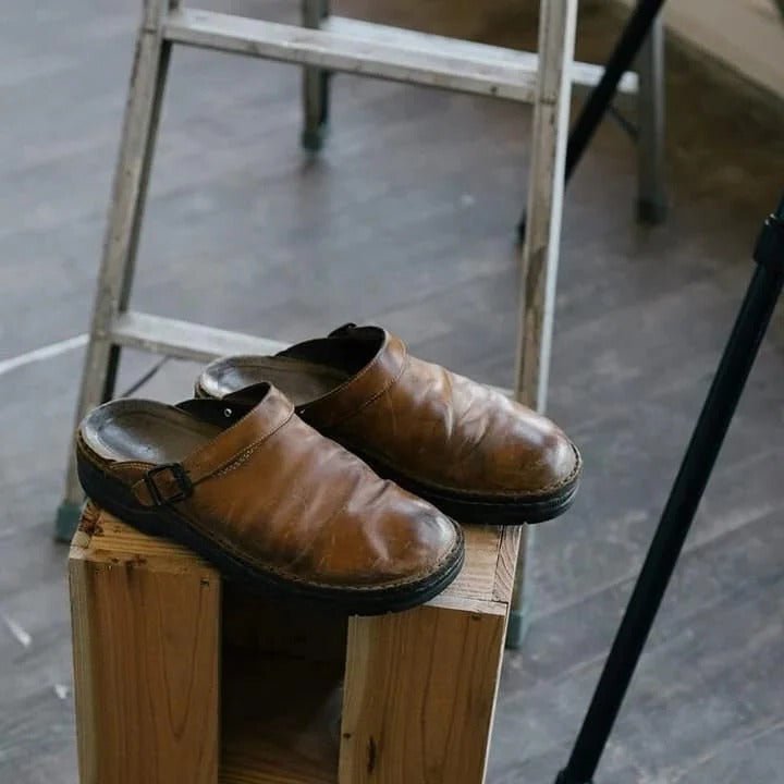 Comfortable men's mules, a casual slip-on design featuring an adjustable heel strap for secure wear.