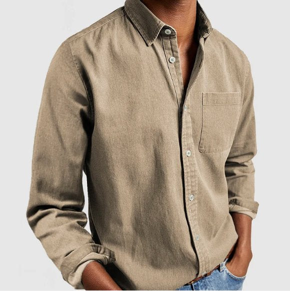 Detail shot of the classic button placket on a men's blue denim long sleeve button-up shirt for timeless style.