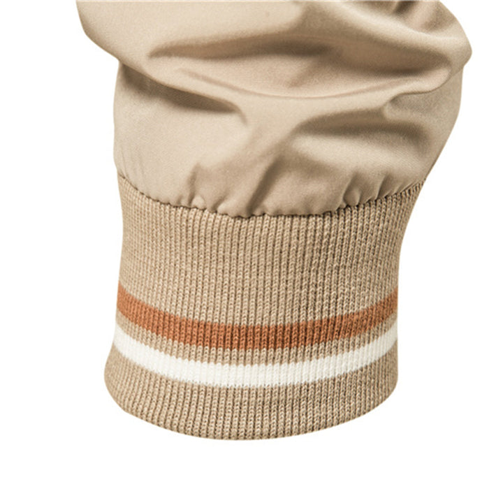 Man modeling a classic men's bomber jacket, showcasing ribbed trim & sleek design for casual style.