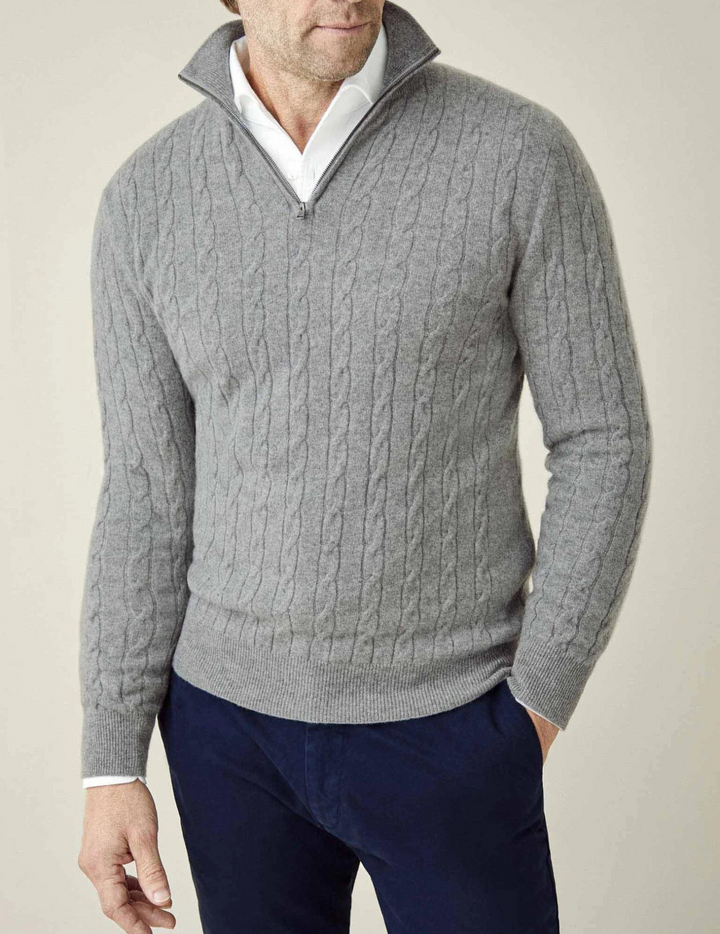 Classic men's cable-knit quarter-zip sweater, combining tradition with modern comfort.
