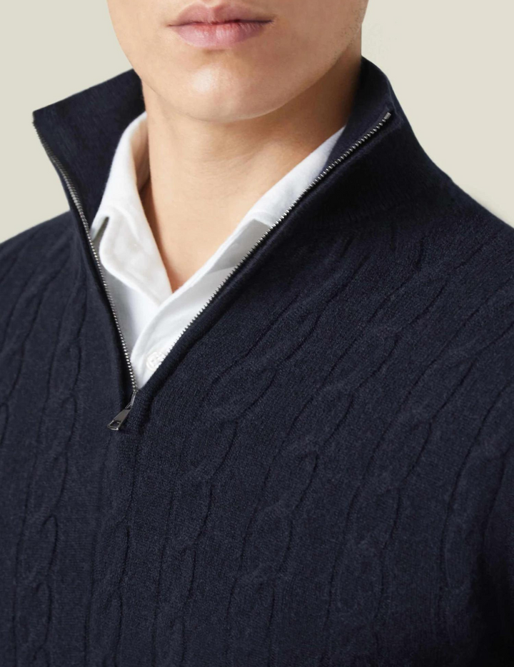 Man wearing a sophisticated cable-knit quarter-zip sweater, showcasing its elegant fit.