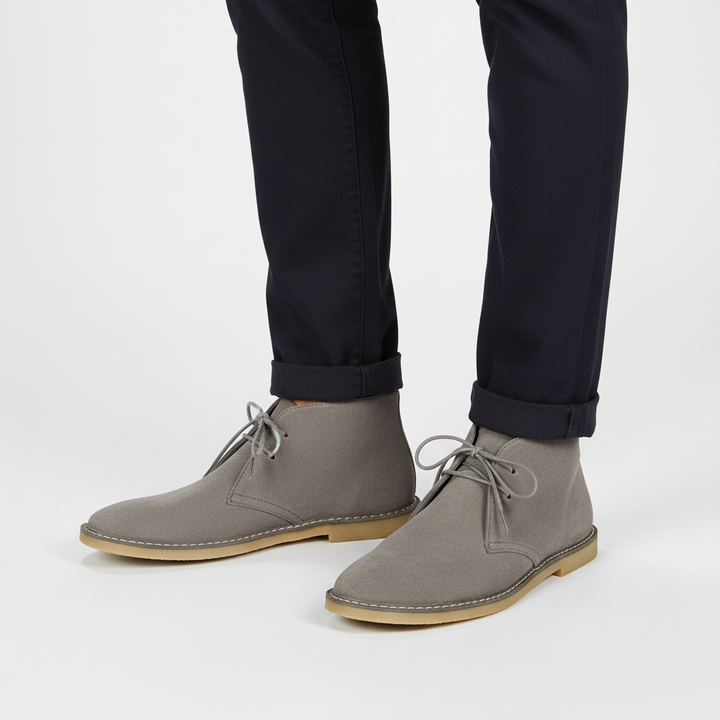 Pair of men's classic desert boots, ready for everyday wear, providing timeless style & comfort.