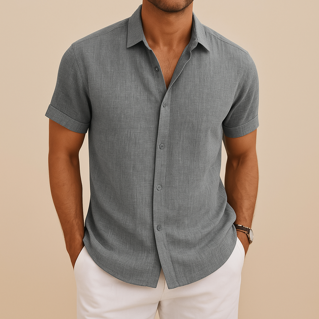 Close-up of a men's collared long sleeve shirt, showing fine fabric and button-down detail. Smart casual.
