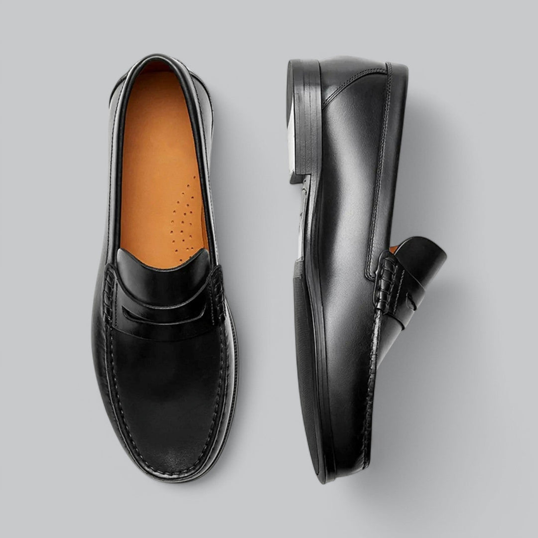 Comfortable men's slip-on penny loafers in black leather, ideal for versatile everyday and dressy occasions.