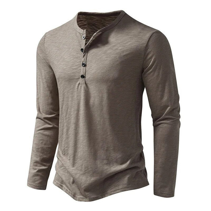 Soft cotton blend men's slim fit long sleeve Henley, ideal for comfortable casual wear.