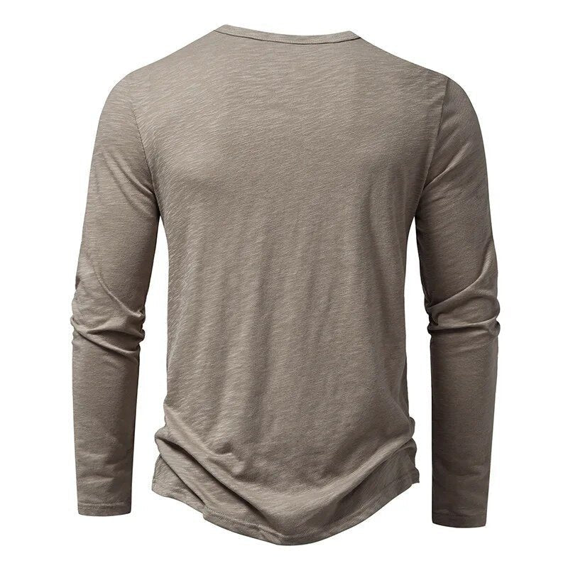 Classic men's slim fit Henley shirt with button placket & long sleeves for stylish casual looks.