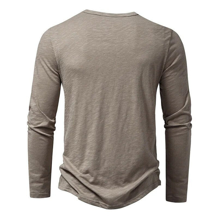 Classic men's slim fit Henley shirt with button placket & long sleeves for stylish casual looks.