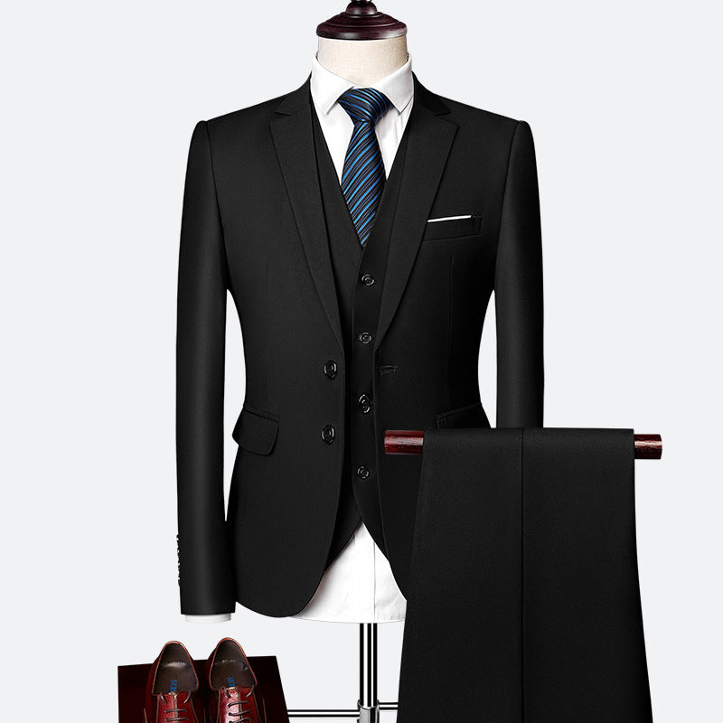 Tailored men's three-piece suit in navy, showcasing fabric texture, slim lapels & waistcoat details.