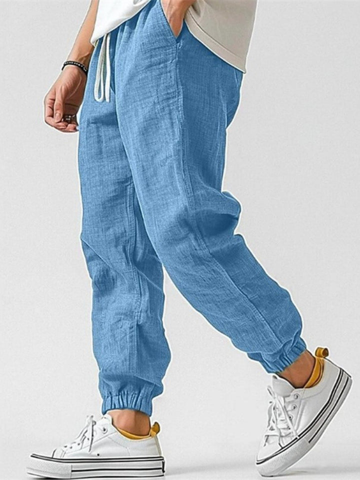 Men's casual trackpants, tapered fit joggers with cuffed ankles, designed for comfort & active leisure.