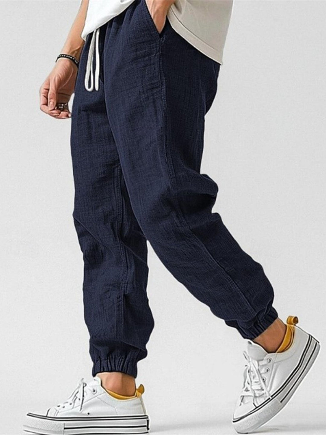 Comfortable men's drawstring joggers, tapered fit & cuffed ankles, essential for modern men's apparel.