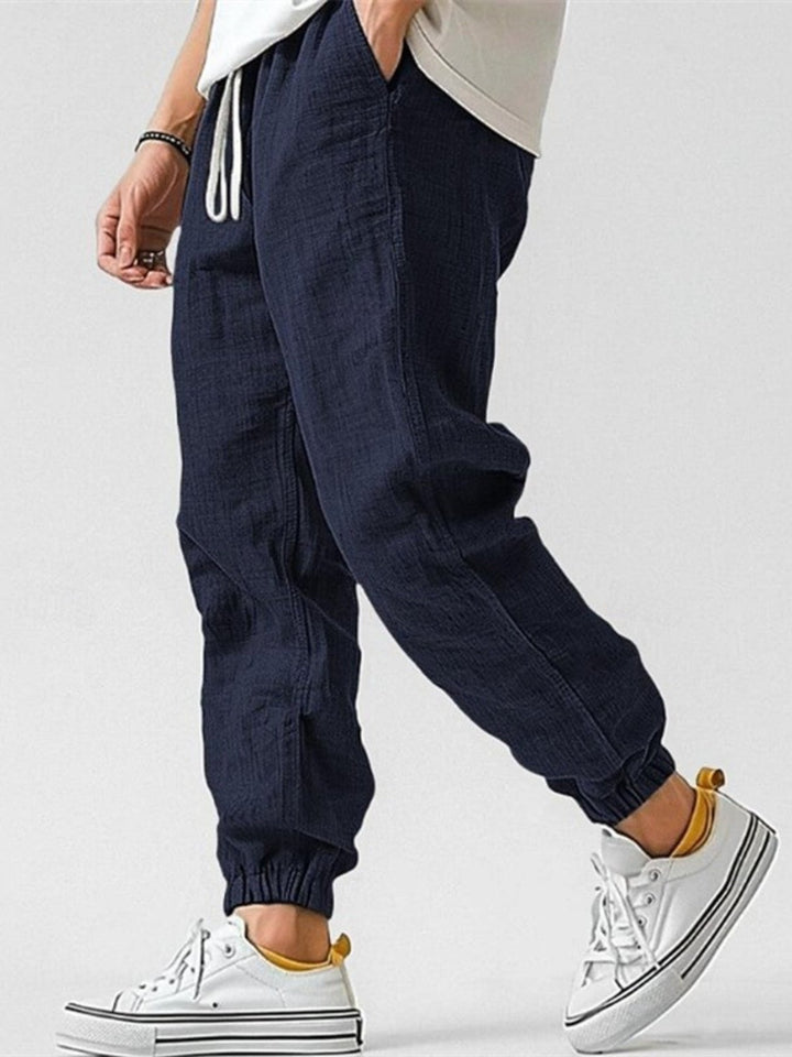 Comfortable men's drawstring joggers, tapered fit & cuffed ankles, essential for modern men's apparel.
