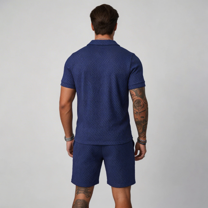 Men's warm weather set featuring a zip collar polo shirt and matching textured shorts. Great for a casual look.