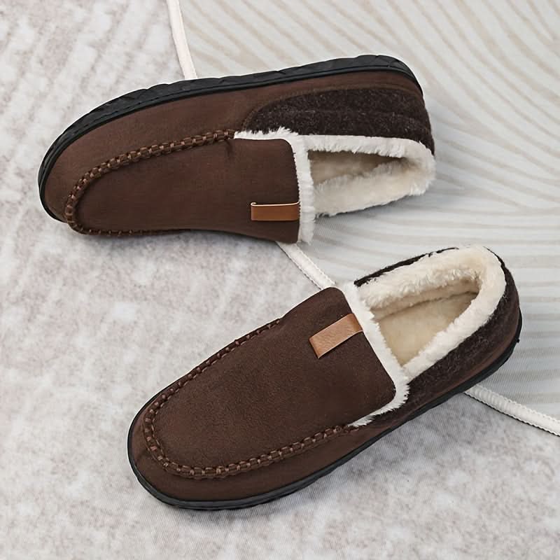 A pair of men's warm slip-on house shoes, designed for cozy indoor comfort in winter.