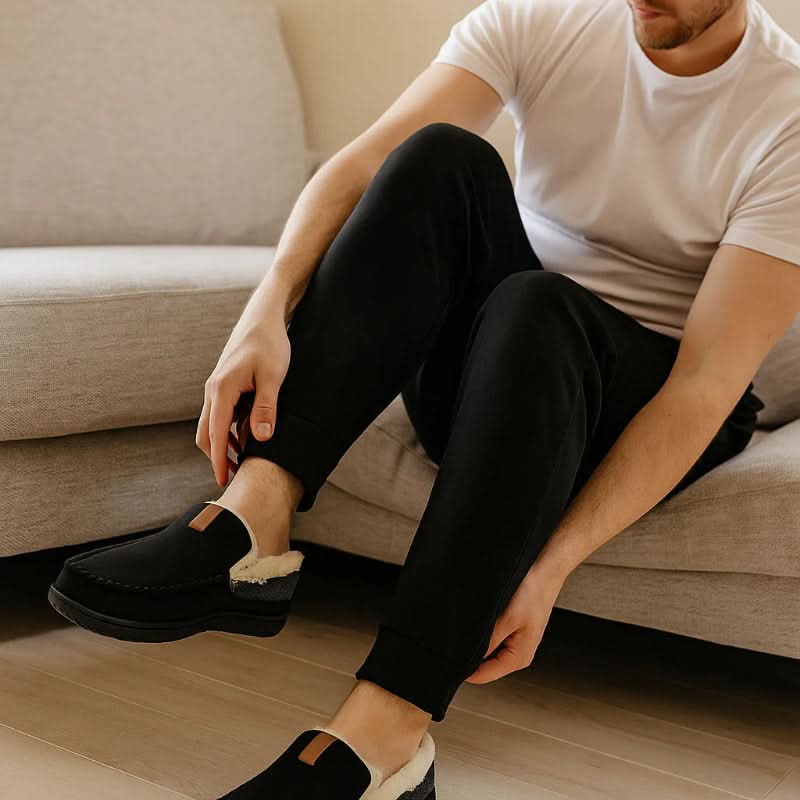 Plush men's slip-on house shoes, offering cozy warmth and comfort for indoor winter wear.