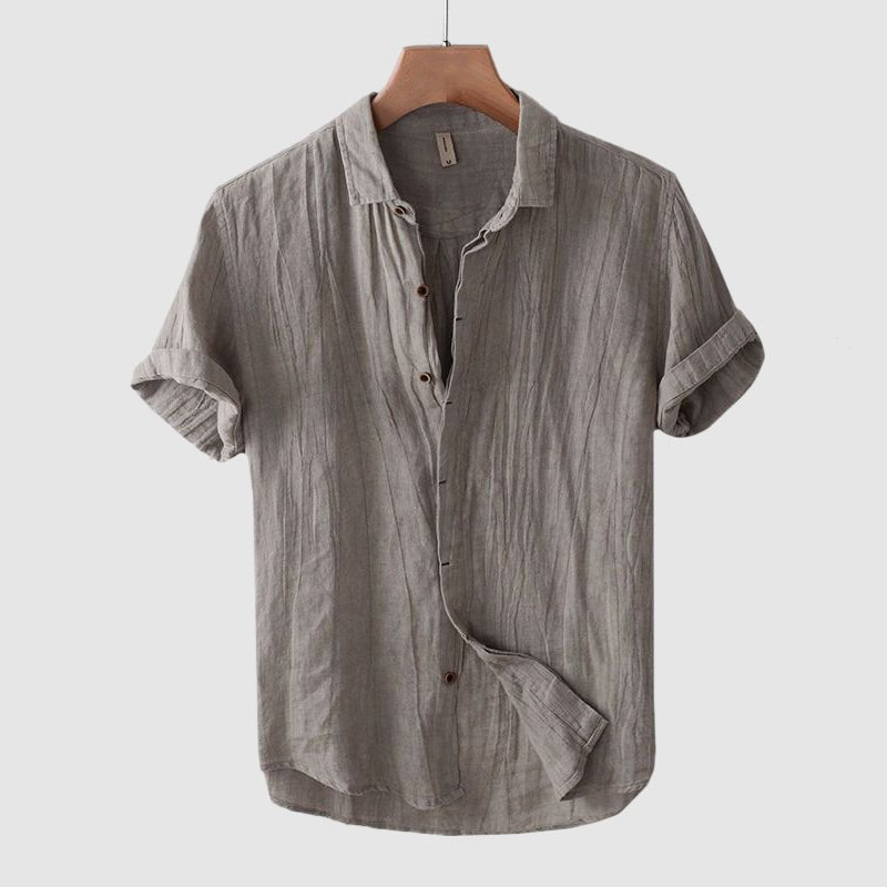 Man wearing a stylish crinkle short sleeve shirt, showcasing its effortless fit and casual summer vibe.