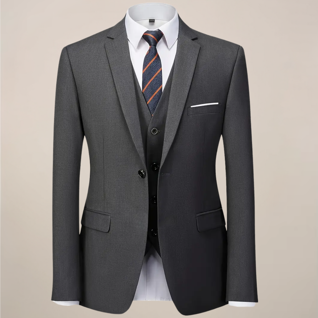Stylish men's dark grey slim fit three-piece suit, featuring jacket, vest, and trousers for sophisticated event attire.