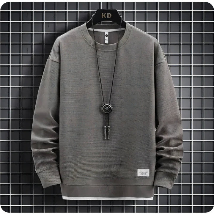 Two-piece men's knit lounge set with relaxed fit joggers & cozy sweater for casual comfort.