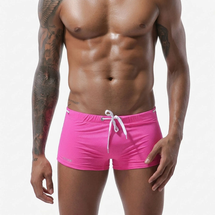 Textured men's fitted low-rise swim trunks, ideal for active beachwear & swimming.