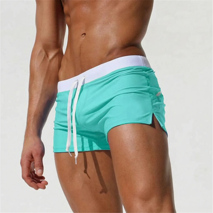 Modern men's fitted quick-dry swim trunks, offering a sleek look for beach, pool, and summer activities.