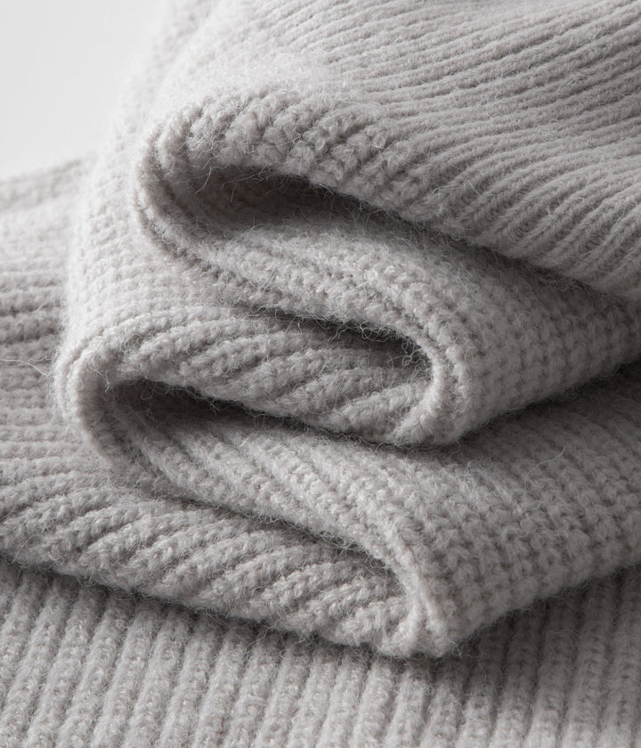 Man in a smart casual outfit, featuring a modern men's funnel neck zip-up sweater for layering.