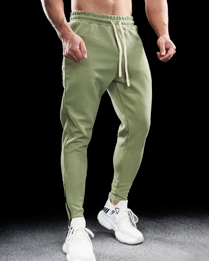 Close-up of men's Girona tapered joggers. Features zip hems and soft fabric for comfort.