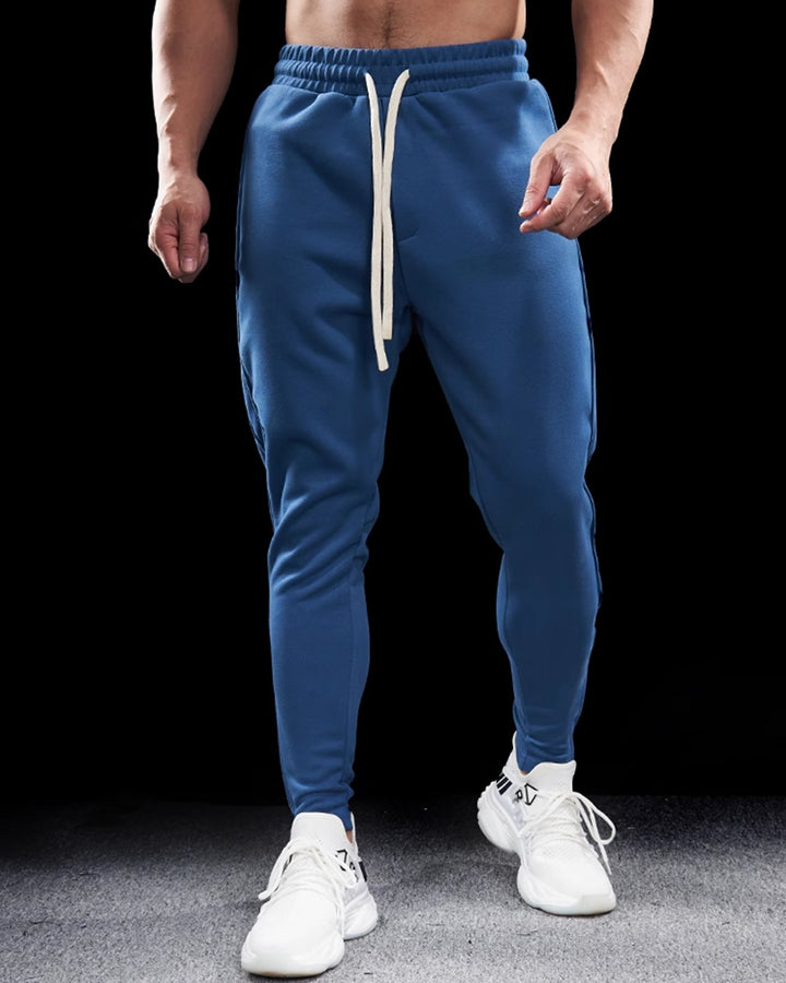 Sleek men's Girona tapered joggers with zip detail. Modern athletic pants for active lifestyles.