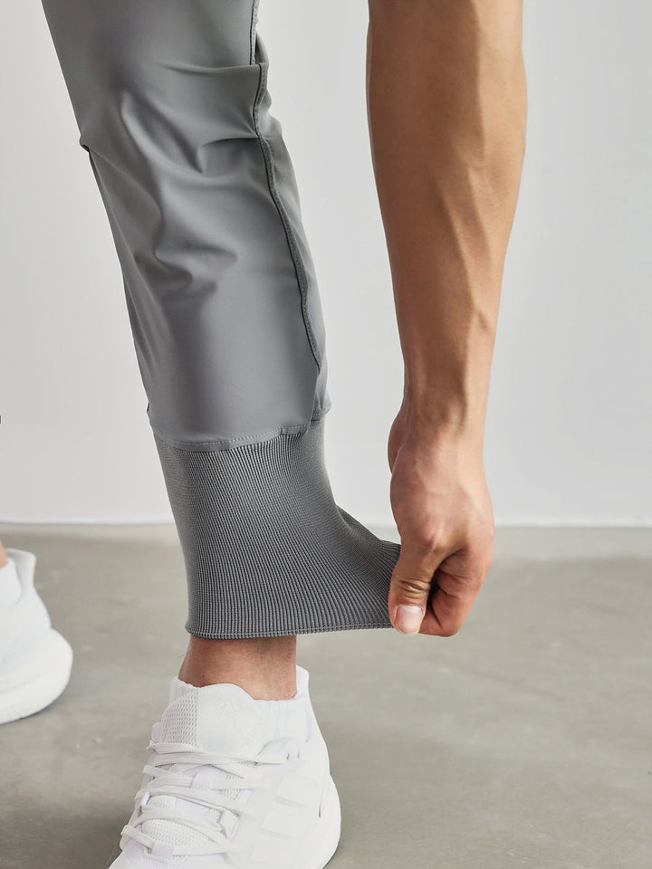 Tapered fit men's joggers with spacious cargo pockets, versatile for activewear or casual fashion.