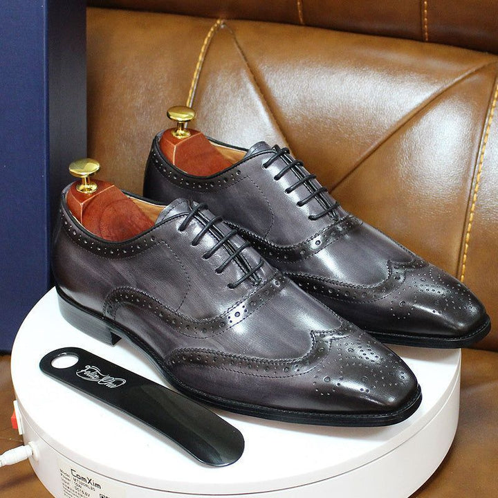 Elegant men's brown leather wingtip Oxford shoes with detailed brogue stitching, ideal for sophisticated dress.