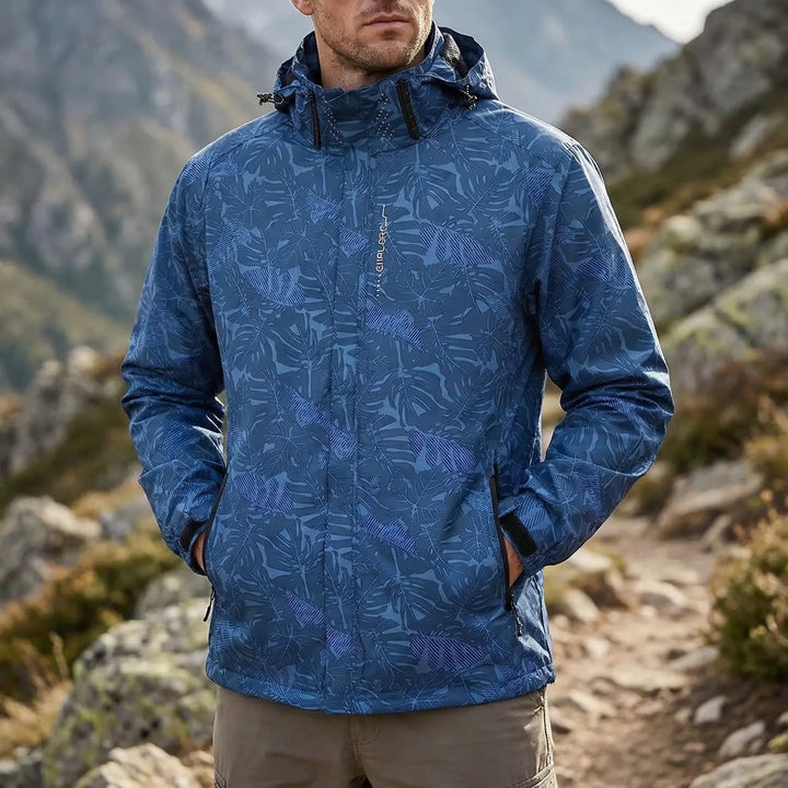 Men's hooded full-zip windbreaker shell jacket in a botanical print, perfect for outdoor adventures & hiking.