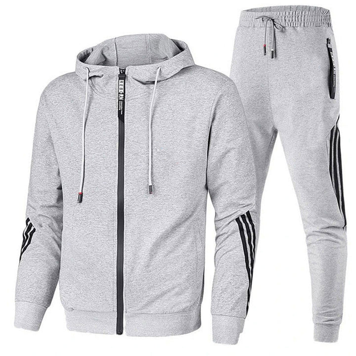 Relaxed man in a comfortable men's hooded jogger set. Versatile two-piece lounge wear and casual outfit.