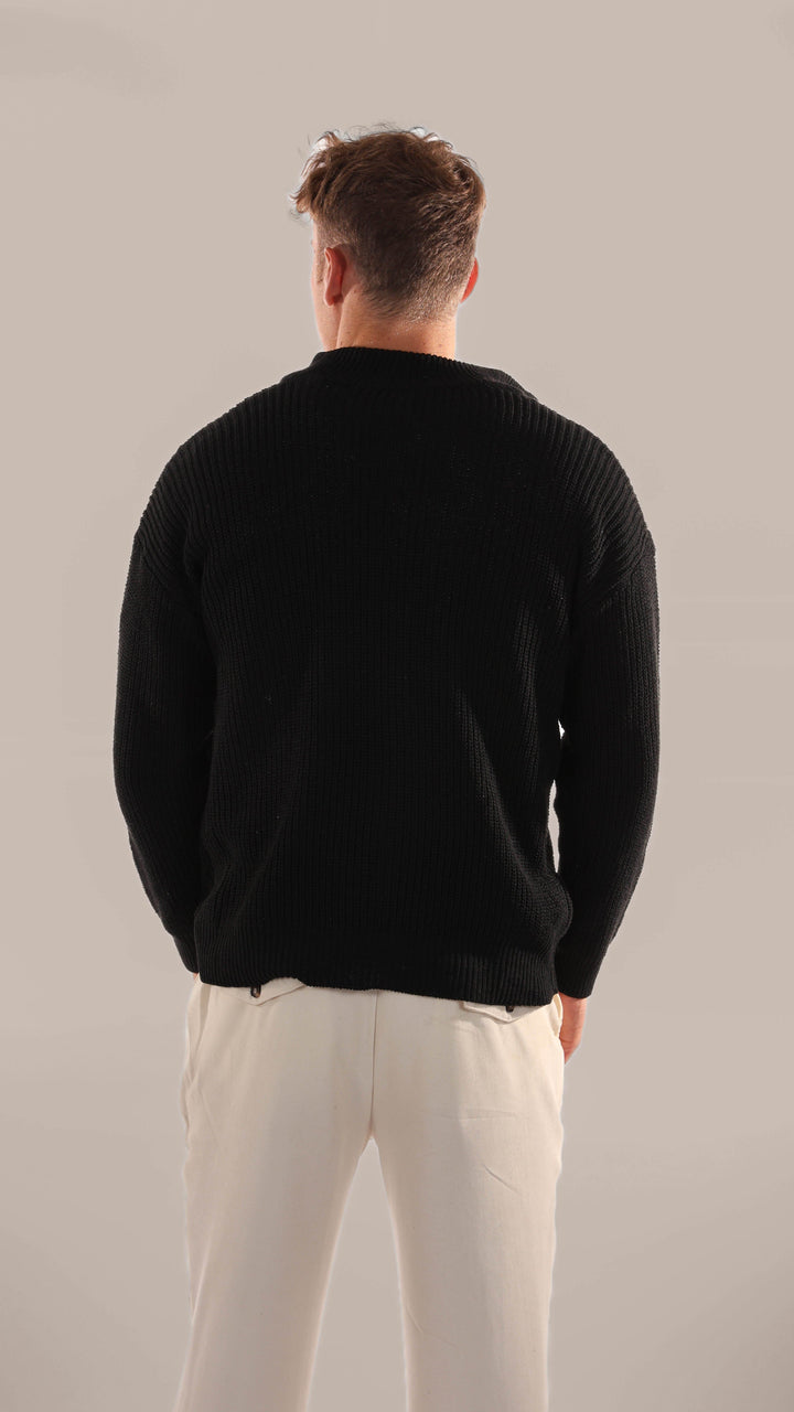 Close-up of a men's knitted half zip sweater, showcasing texture & long sleeves for winter layering.
