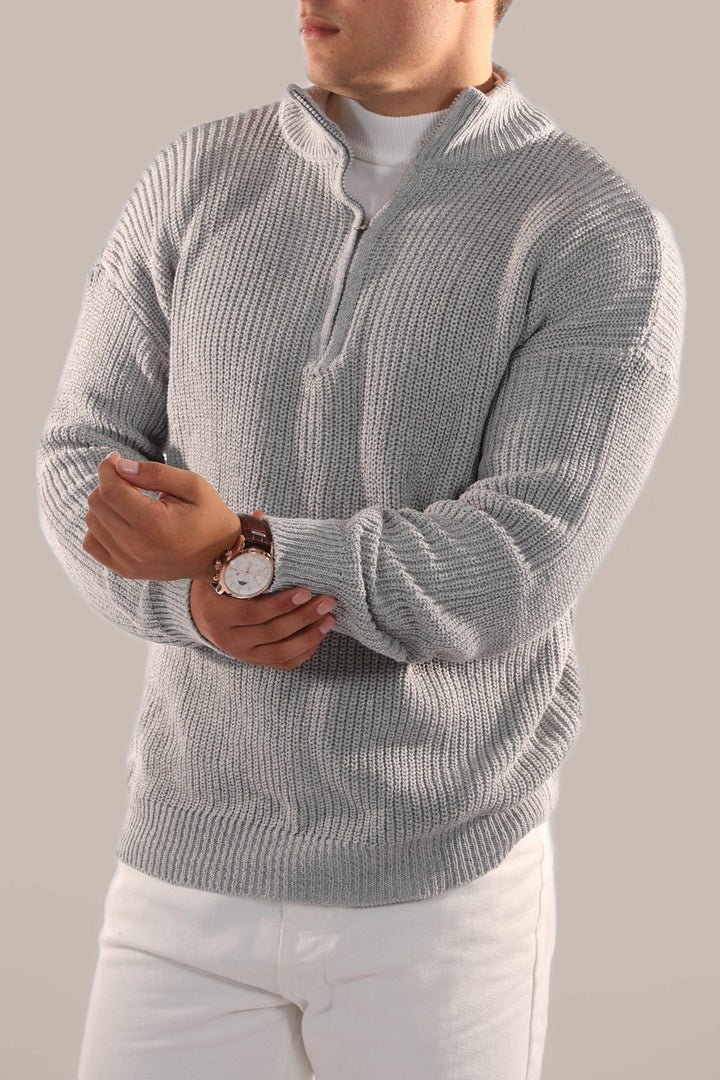 Man wearing a stylish half zip knitted jumper, suitable for versatile everyday smart casual fall outfits.