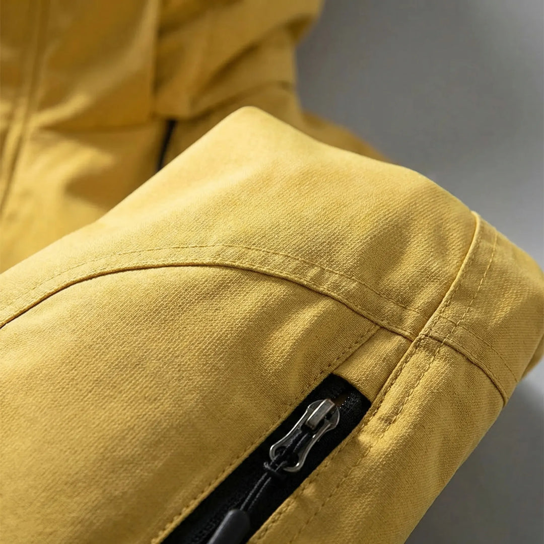 Man hiking in a lightweight men's hooded softshell jacket, perfect for outdoor exploration & camping.