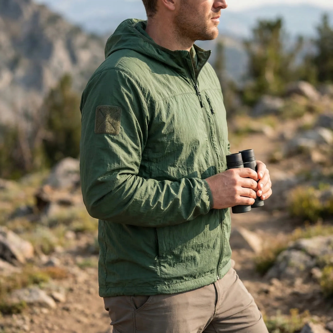 Men's lightweight hooded tactical windbreaker jacket in black, ideal for outdoor wear & active travel.